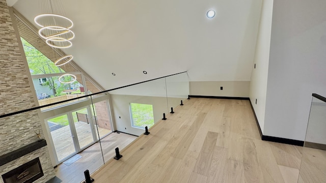 2154 Valleyview Dr, Bushkill, PA 18324 - corridor featuring a chandelier, high vaulted ceiling, baseboards, and wood finished floors