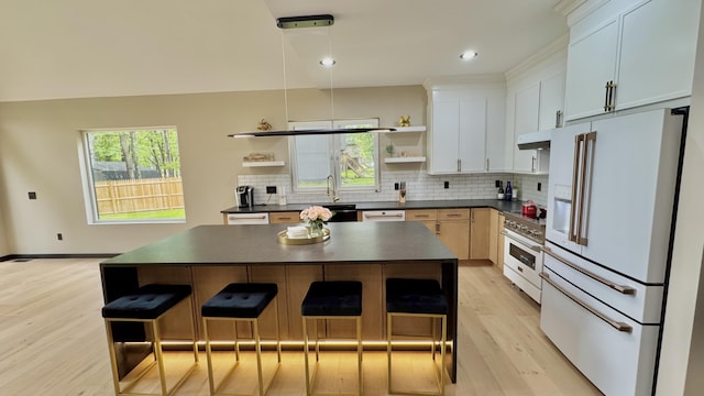 2154 Valleyview Dr, Bushkill, PA 18324 - kitchen with white appliances, open shelves, dark countertops, light wood-style floors, and a kitchen bar