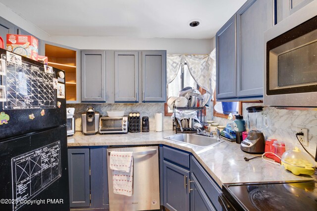 kitchen with light carpet, electric range, gray cabinets, and kitchen peninsula