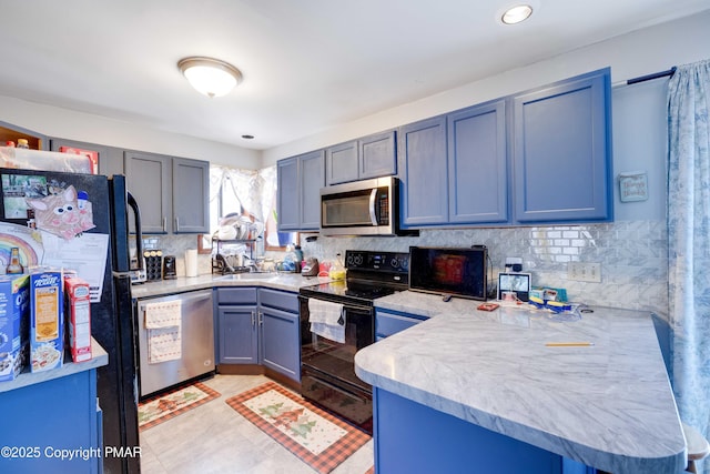 kitchen featuring tasteful backsplash, kitchen peninsula, sink, and black appliances