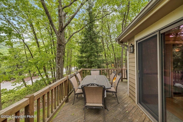 wooden terrace with outdoor dining area