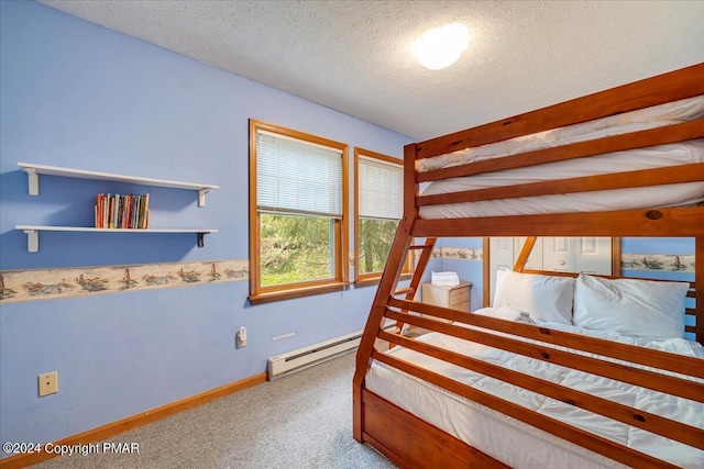 bedroom with carpet, baseboards, a textured ceiling, and baseboard heating