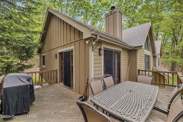 deck featuring outdoor dining space and a grill