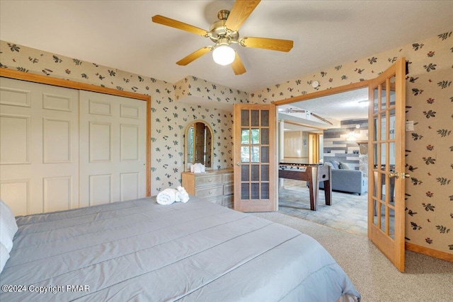 bedroom with ceiling fan, carpet floors, french doors, a closet, and wallpapered walls