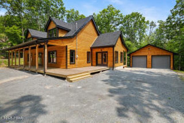 118 Eagle Rock Rd, Lackawaxen, PA 18435 - chalet / cabin with a detached garage, an outdoor structure, and a deck