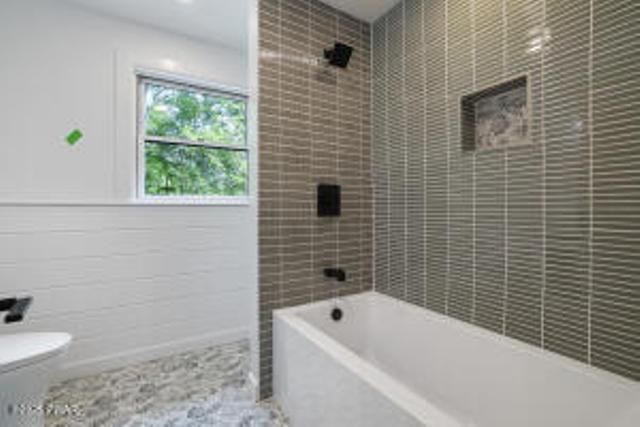 118 Eagle Rock Rd, Lackawaxen, PA 18435 - bathroom featuring shower / bathtub combination and tile walls