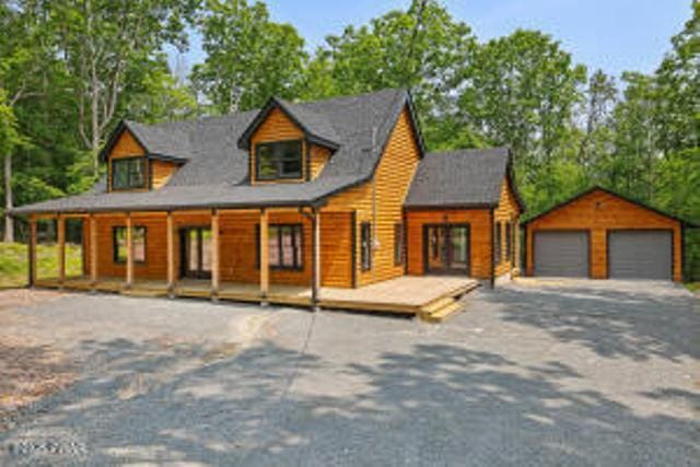 118 Eagle Rock Rd, Lackawaxen, PA 18435 - chalet / cabin with a garage, an outbuilding, and covered porch