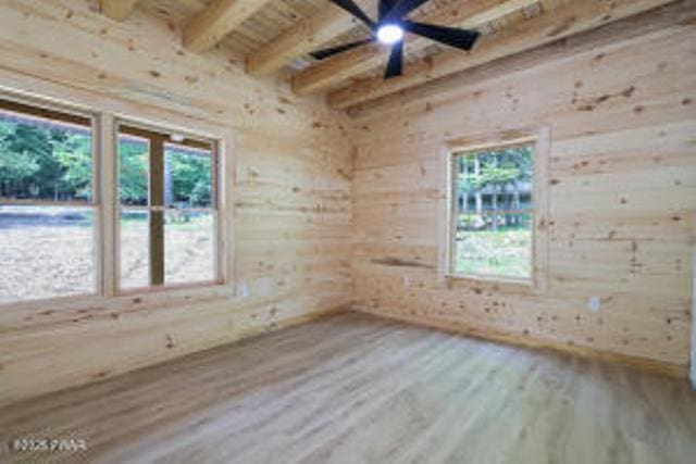 118 Eagle Rock Rd, Lackawaxen, PA 18435 - unfurnished room with wood finished floors, beam ceiling, and wood walls