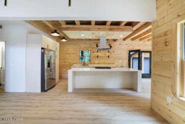 118 Eagle Rock Rd, Lackawaxen, PA 18435 - kitchen featuring stainless steel fridge, white cabinetry, light wood-type flooring, beam ceiling, and light countertops