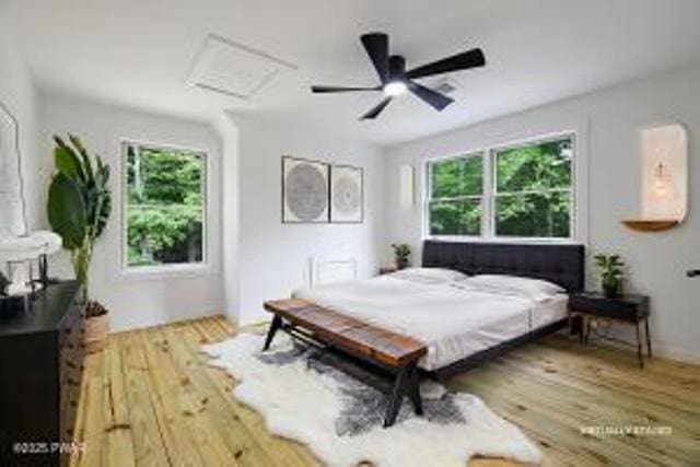 118 Eagle Rock Rd, Lackawaxen, PA 18435 - bedroom with attic access, multiple windows, wood finished floors, and a ceiling fan