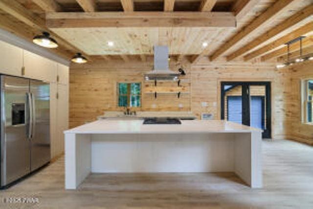 118 Eagle Rock Rd, Lackawaxen, PA 18435 - kitchen featuring stainless steel refrigerator with ice dispenser, light wood-type flooring, beamed ceiling, light countertops, and black electric cooktop