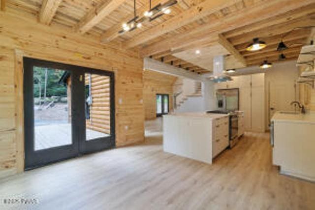 118 Eagle Rock Rd, Lackawaxen, PA 18435 - kitchen with light wood-type flooring, wood walls, light countertops, a wood ceiling with exposed beams, and decorative light fixtures