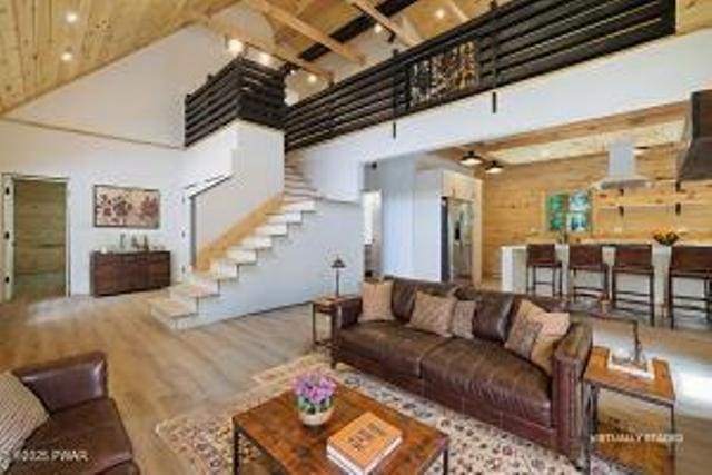 118 Eagle Rock Rd, Lackawaxen, PA 18435 - living area with a towering ceiling, stairs, wood finished floors, and a wood ceiling with exposed beams