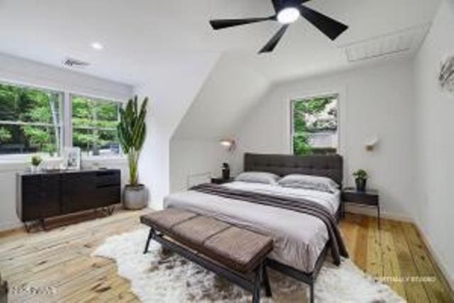 118 Eagle Rock Rd, Lackawaxen, PA 18435 - bedroom featuring multiple windows, wood finished floors, vaulted ceiling, and ceiling fan