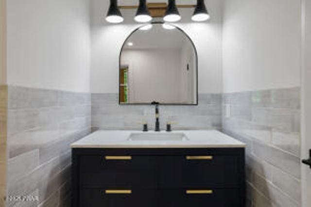 118 Eagle Rock Rd, Lackawaxen, PA 18435 - bathroom featuring vanity, tile walls, and a wainscoted wall