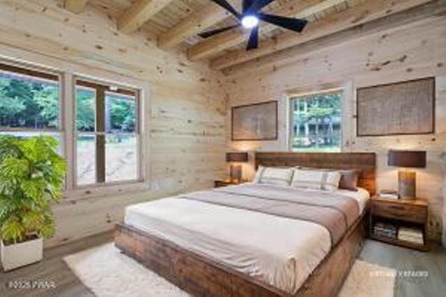 118 Eagle Rock Rd, Lackawaxen, PA 18435 - bedroom featuring multiple windows, wood finished floors, and a wood ceiling with exposed beams