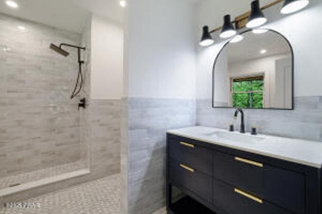 118 Eagle Rock Rd, Lackawaxen, PA 18435 - full bathroom featuring vanity, a tile shower, tile walls, a wainscoted wall, and recessed lighting