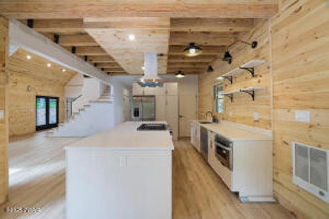 118 Eagle Rock Rd, Lackawaxen, PA 18435 - kitchen featuring light wood-style floors, open shelves, beam ceiling, light countertops, and wood walls