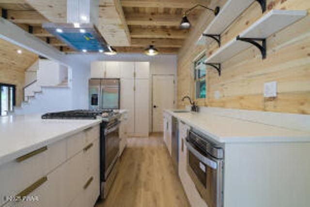 118 Eagle Rock Rd, Lackawaxen, PA 18435 - kitchen with appliances with stainless steel finishes, open shelves, light wood-type flooring, white cabinetry, and light countertops