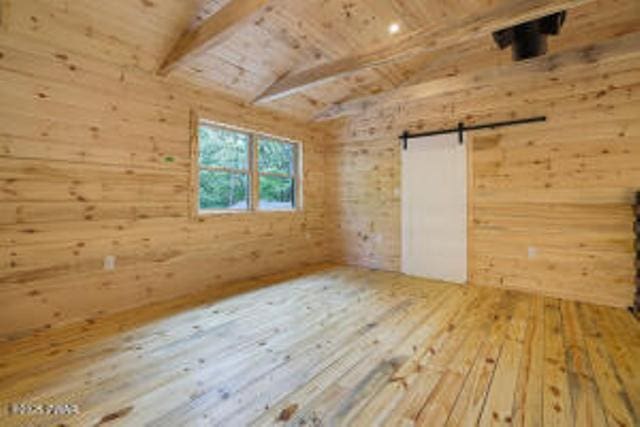 118 Eagle Rock Rd, Lackawaxen, PA 18435 - additional living space with hardwood / wood-style floors, wooden ceiling, wooden walls, and a barn door
