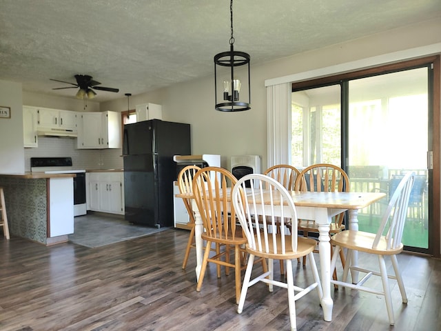 911 Granite Ter, Tobyhanna, PA 18466 - dining room with a textured ceiling, dark wood-style flooring, a ceiling fan, and heating unit