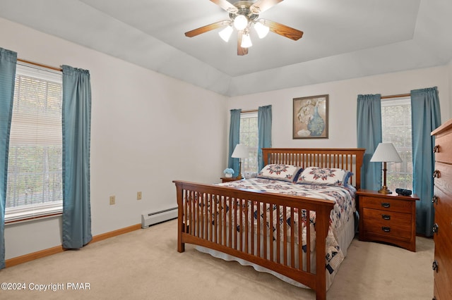 bedroom with baseboards, a raised ceiling, lofted ceiling, a baseboard radiator, and carpet