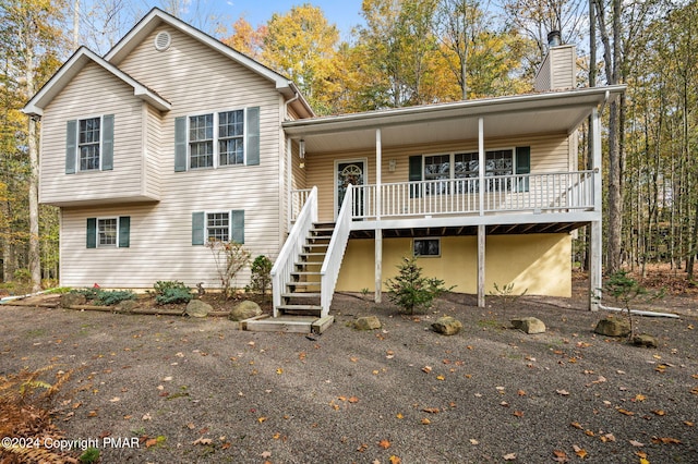 split level home with a chimney and stairs