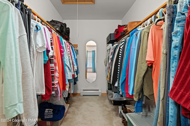 walk in closet featuring attic access, baseboard heating, and carpet flooring