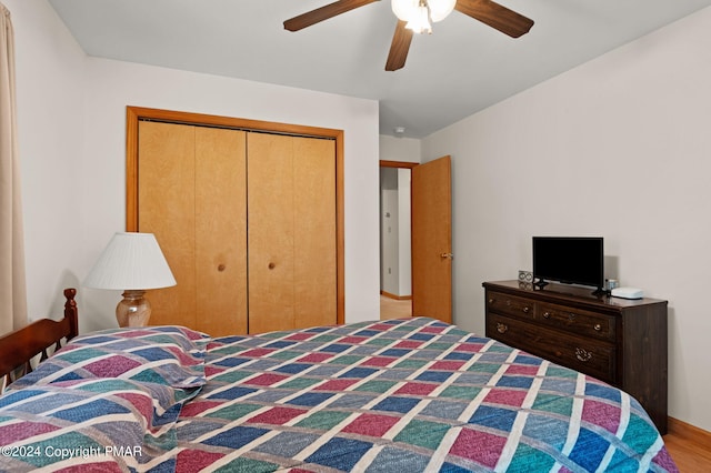 bedroom featuring ceiling fan, a closet, and wood finished floors