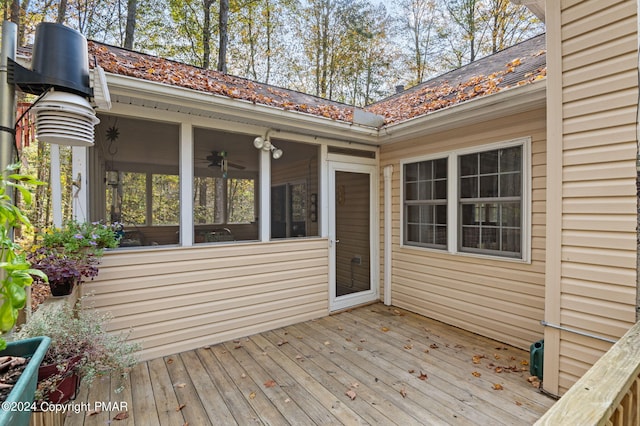 wooden deck with a sunroom