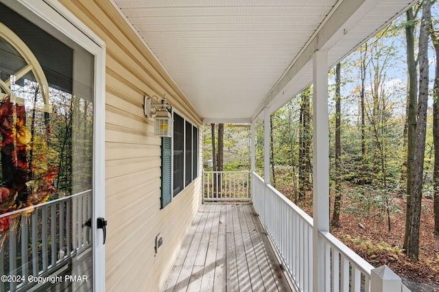 wooden terrace featuring covered porch