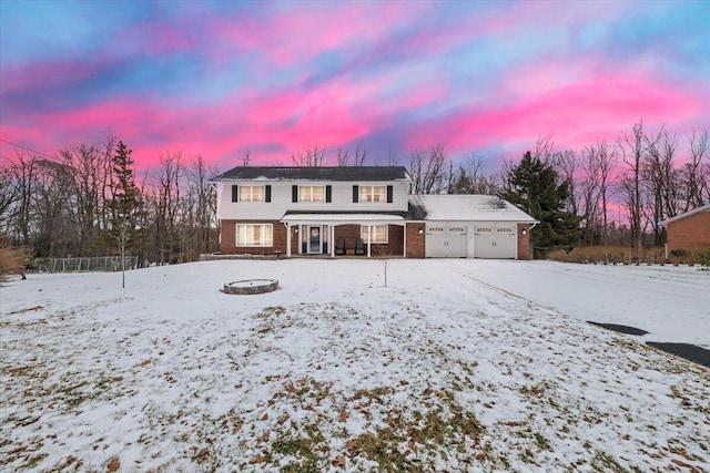 traditional-style home with brick siding and an attached garage