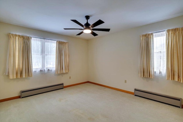 carpeted spare room with a baseboard radiator, ceiling fan, and baseboards