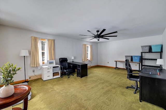 carpeted office featuring a ceiling fan and baseboards