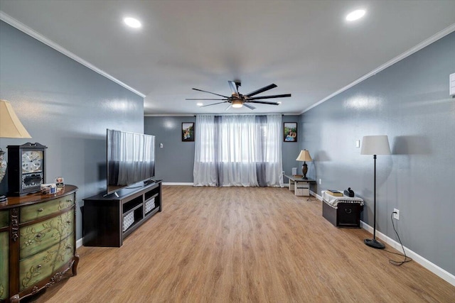 interior space featuring baseboards, ornamental molding, and wood finished floors