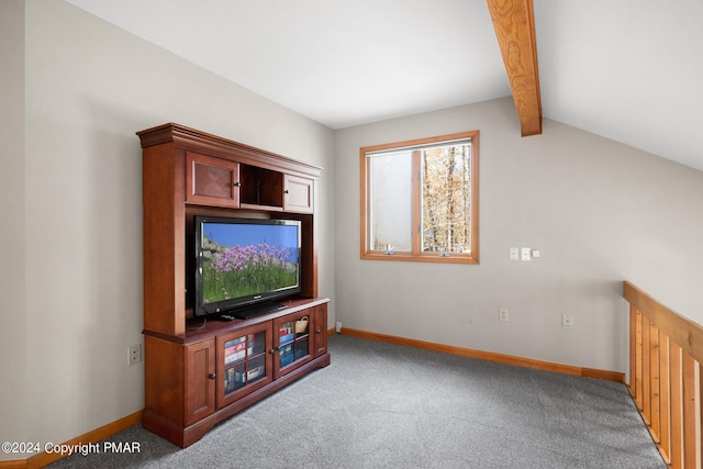 living area featuring lofted ceiling with beams, carpet flooring, and baseboards