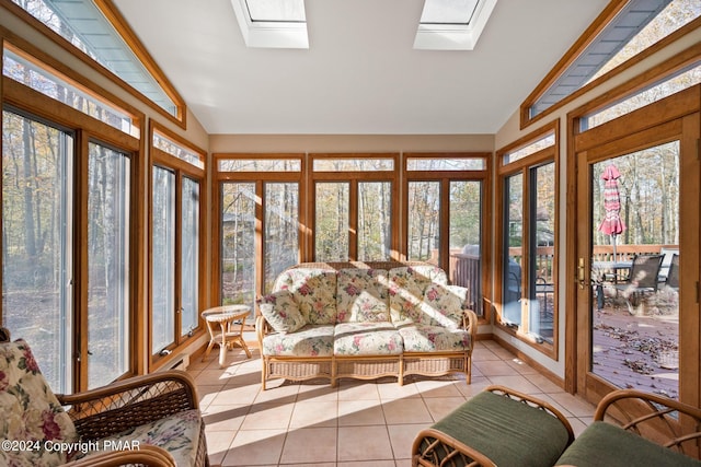 sunroom with lofted ceiling with skylight and a wealth of natural light