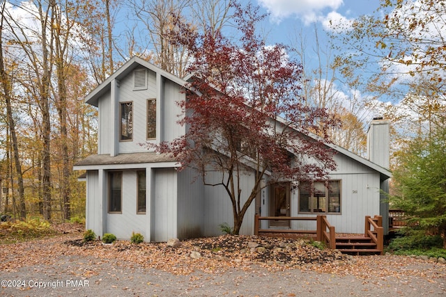 261 Aspen Rd, Pocono Pines, PA 18350 - view of front facade with covered porch, roof with shingles, and a chimney