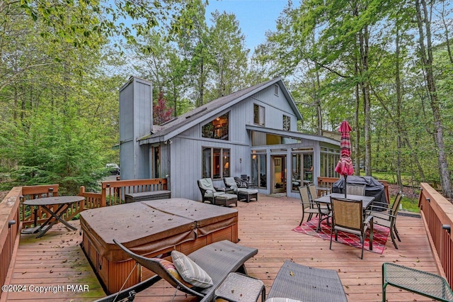 deck featuring an outdoor hangout area, outdoor dining area, and a covered hot tub