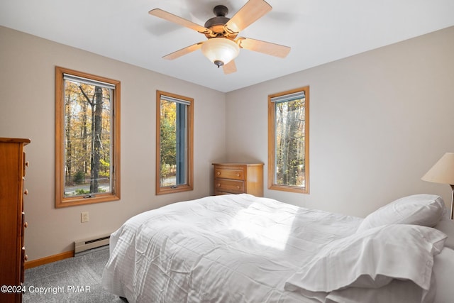 bedroom featuring a ceiling fan, baseboards, a baseboard heating unit, and carpet flooring