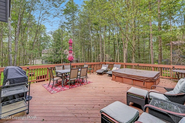 deck featuring outdoor dining space and a hot tub