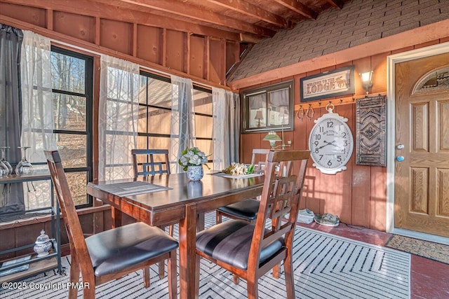 dining room featuring wooden walls