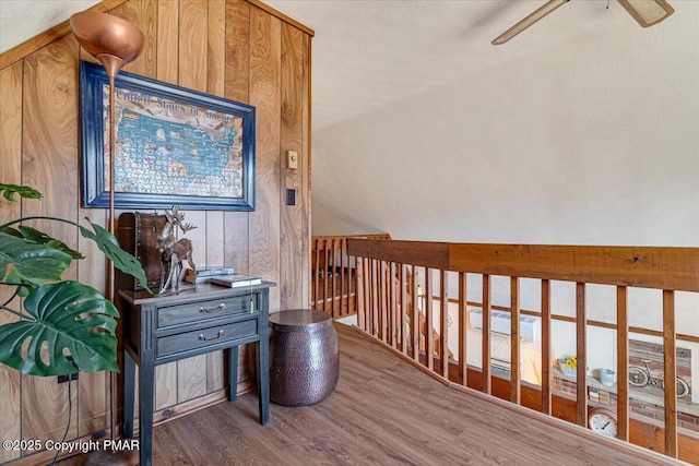 hallway featuring vaulted ceiling and wood finished floors