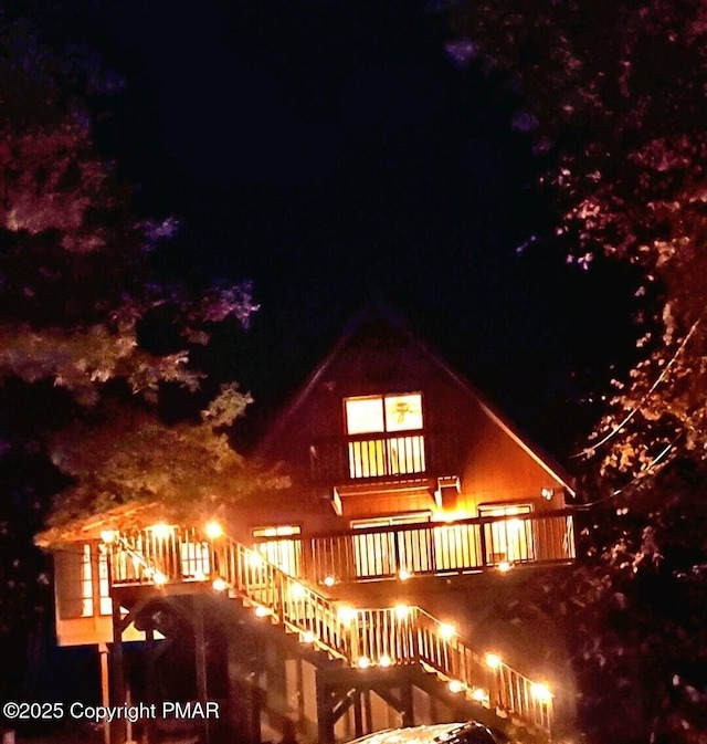 view of back of house at night