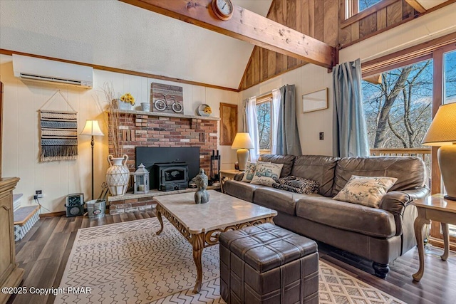 living room featuring a wall mounted AC, wood finished floors, a wood stove, and wood walls