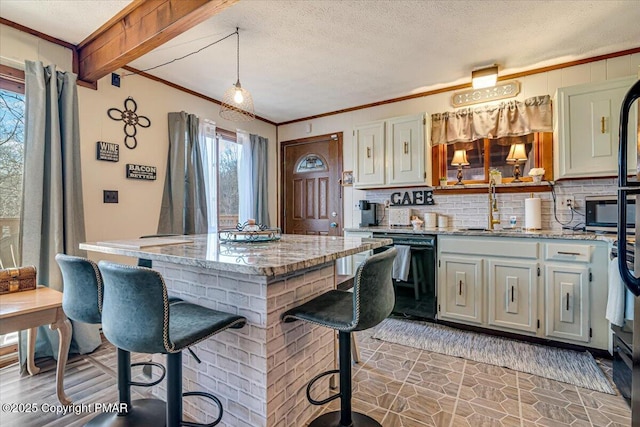 kitchen with dishwasher, a sink, crown molding, a center island, and decorative backsplash