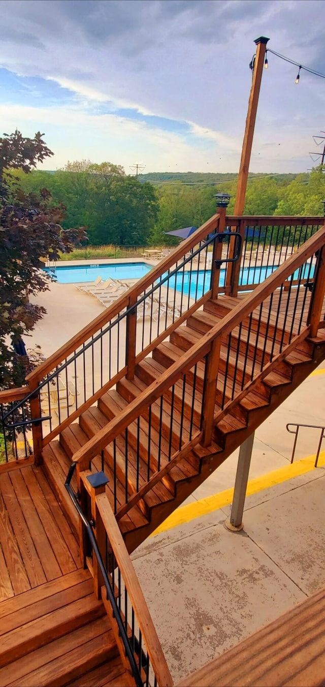 wooden terrace with a community pool