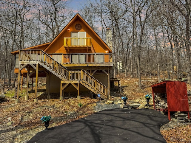 rustic home featuring stairway and a deck