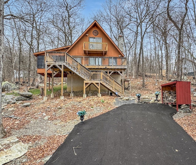rustic home featuring stairs and a deck