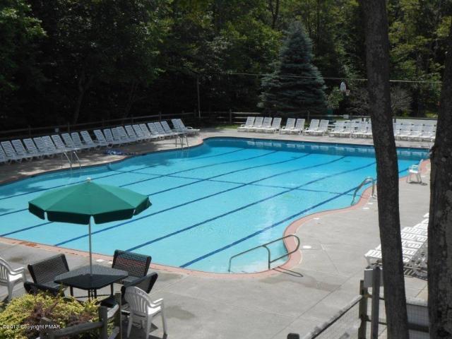 pool featuring fence and a patio area